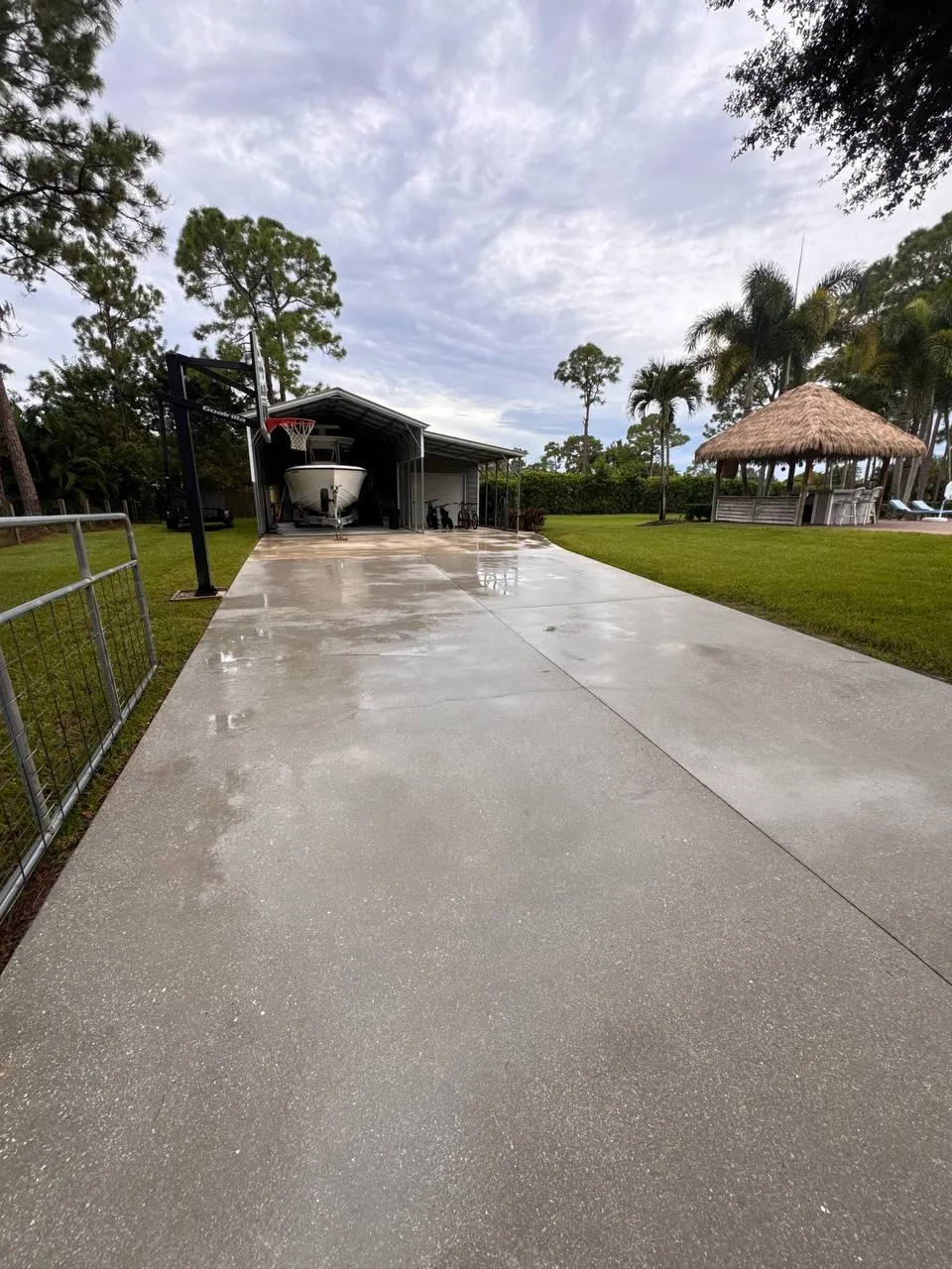 Concrete driveway pressure washing in The Acreage, after