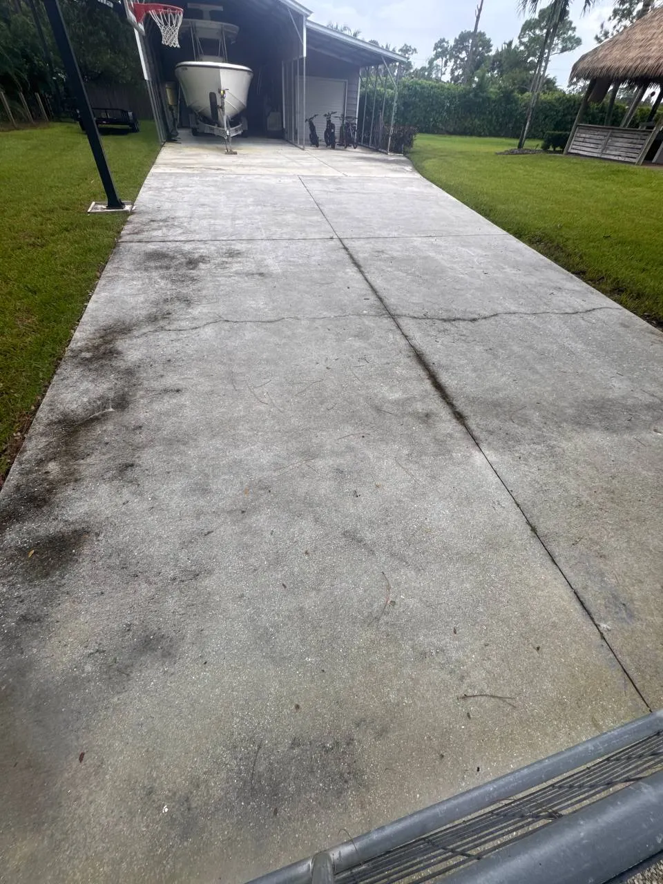 Concrete driveway pressure washing in The Acreage, before